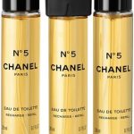 Three bottles of Chanel No. 5 Eau de Toilette refill, 20ml each, with sleek black and gold caps for luxury fragrance
