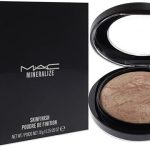 MAC Mineralize Skinfinish compact powder next to black box packaging for radiant skin finish makeup product