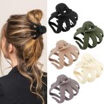 Woman wearing black hair claw clip, showcasing five additional claw clips in various colours for styling options