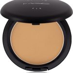 Open compact powder case with beige makeup inside, matte black MAC Studio Fix packaging for flawless skin application